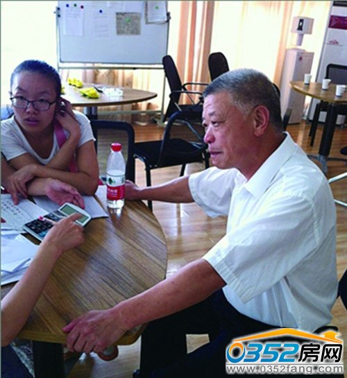 65岁售楼先生郭师傅正在为顾客讲解